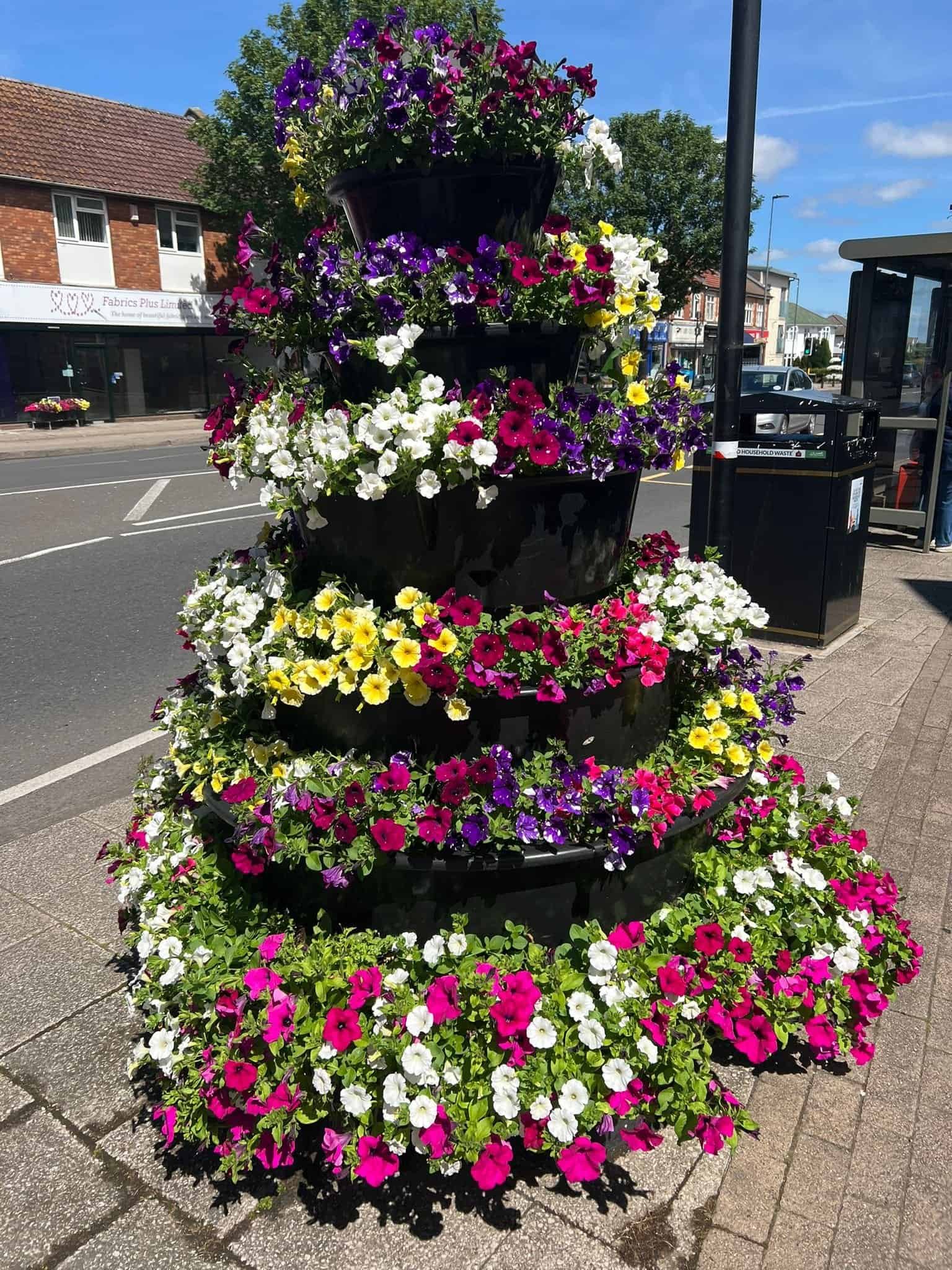 Filling a 25-litre reservoir on a Downend in Bloom flower display